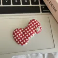 Close-up detail of a red and white plaid bow hair clip, featuring cute sweet style design. - Plaid Bow