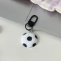 Soccer ball keychain detail view, black and white football bag charm with metal clasp, casual. - Football