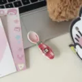Detail shot of a cute West Highland white terrier spoon accessory with red plaid handle on cozy desk setup. - Red Grid