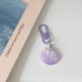 Purple gradient shell keychain detail, cute pearl and star decor, resin bag charm accessory. - Purple
