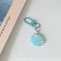 Blue gradient shell keychain detail view, featuring cute pearl and star accents with metal clasp. - Blue