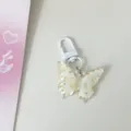 Translucent floral butterfly keychain detail, clear jelly pendant charm for bag or keys. - Yellow
