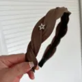 Brown braided headband detail, close up view showing star rhinestone embellishment and pleated fabric texture. - Dark Brown Star Rhinestone Braided Headband