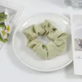 Light green satin hair scrunchie detail view, elegant elastic hair tie for chic daily hairstyles. - Elegant Green