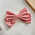 Détail de pince à cheveux nœud en velours rose, design doux et texture souple, bel accessoire. - Barrette à Ressort Nœud Papillon / Rose