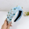 Light blue knotted fabric headband with sparkling rhinestones and cute volleyball charms for women. - Light Blue