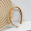 Orange matte wavy plastic headband for women, stylish solid color non-slip hair hoop. - Orange