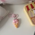 Cute pink pig ice cream cone keychain detail view, soft cartoon pendant showing close up. - Ice Cream Cone
