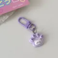 Cute purple cat paw keychain detail, perfect accessory for schoolbags and keys. - Purple