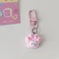 Close up detail of cute pink cat paw keychain pendant with lovely cat face relief design. - Pink