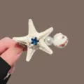 Pinza de pelo estrella de mar perla, elegante horquilla pico de pato para estilo tierno. - Pinzas para el cabello de estrella de mar beige con estrás azul claro