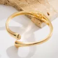 Minimalist gold open bangle bracelet with sleek teardrop ends, elegant metal cuff for women. - Narrow Irregular Oval Bracelet / Gold