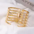 Gold open metal cuff bracelet for women, edgy hollow bone design, stylish vintage arm jewelry. - Irregular Ring Mouth Bracelet / Gold
