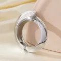 Chunky silver metal open bangle bracelet for women, modern thick geometric arm ring jewelry piece. - Asymmetric Arc Surface Bracelet / Silver