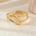 Gold open cuff bracelet for women, stylish metal twist arm ring vintage jewelry accessory. - Hollow Wing Bracelet / Gold