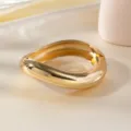 Chunky gold teardrop statement bangle bracelet, sleek metallic fashion arm cuff jewelry. - Smooth Arc Wave Bracelet / Gold
