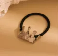 Black hair tie with silver crown ornament, elastic ponytail holder for stylish hairstyles. - Silver Crown