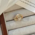 Gold open ring, minimalist interlocking metal finger ring, vintage chic fashion jewelry variant. - Golden Double Ring Buckle