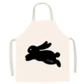 Detail view of beige kitchen apron with black jumping rabbit graphic and lucky print. - Cartoon Panda Series 5