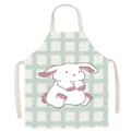 Close up of cotton linen kitchen apron with cute cartoon rabbit print and green grid. - Milo Rabbit