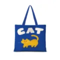 Primo piano della borsa in tela blu con stampa di gatto arancione e design di lettere. - Dopamina Orizzontale Piatta 07 (Cinturino Blu)