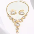 Trendy exaggerated gold-tone statement necklace and earrings set with grey oval stone details. - White Pearl Golden
