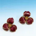 Closeup detail of vintage wine red enamel flower earrings with golden border and textured petals. - Deep Burgundy