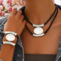 Multi-layer black cord necklace and bracelet set with silver metal bars and oval white pendant. - White and Silver Gray