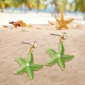 Chic green starfish earrings with crystal and pearl details, perfect for summer beach vacations. - Light Green