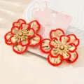 Korean style stylish large flower earrings with striking red rims and gold metallic finish. - Red