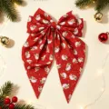 Vista detallada del pasador de pelo lazo rojo con estampado de Papá Noel navideño. - Estampado Papá Noel Rojo