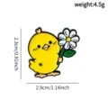 Close-up detail view of the cute little yellow chick holding a daisy alloy brooch badge. - Yellow Chick Holding Daisy (F10-6-1083)