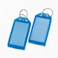 Detailed view of blue plastic key tags with transparent covers and metal split rings. - 5.7x1.8cm / Blue Dashed Line