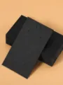 Detail shot of black paper jewelry display cards, perfect for necklace and bracelet packaging. - 5x9cm (50 Pieces/Pack) / Black