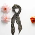 Detail view of a chic patterned skinny scarf featuring a sophisticated animal print and polka dot mix. - Snakeskin Patchwork Zebra Print