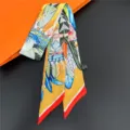 Detailed view of colorful printed twilly silk scarf with feather pattern, elegant accessory. - 23