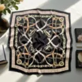 Elegant black square scarf with gold chain and belt print, versatile fashion accessory. - 14 Selection by Image