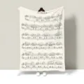 Detailed view of a soft flannel blanket featuring a classic musical score pattern design. - 100x70cm (Throw Blanket) / Sheet Music 01