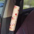 Close up of pink dessert strawberry cream print car seatbelt cover detail in vehicle interior. - Pink Dessert 06