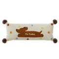 Dettaglio del cuscino lungo con stampa di cagnolino e pompon soffici agli angoli. - Stampa Bifacciale 40X60cm (Senza Imbottitura) / Cane Astratto D (Lungo) Pompon Caffè Scuro