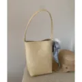 Minimalist beige bucket bag with shoulder strap, elegant silk scarf and cute furry pendant. - With Pendant / Yellow