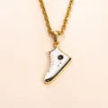 Detail shot of a minimalist gold stainless steel necklace featuring a miniature white sneaker pendant. - DZ1460 White Black