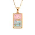 Close-up detail of the gold tarot card macaron necklace with colorful enamel and gemstones. - Macaron Square Necklace