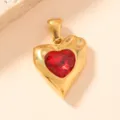 Gold-tone metal heart pendant necklace accessory featuring a vibrant faceted red gemstone centerpiece. - Red