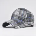 Close-up detail of black and white tweed baseball cap featuring blue grid lines. - Adjustable / Matte Black (01)
