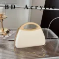 Acrylic hard shell handbag with metal chain strap and top handle in chic white style. - Off White