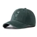 Close-up detail view of the dark green washed baseball cap with cute white embroidery. - Adjustable / Dark Green