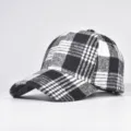 Black and white plaid baseball cap detail view showing fabric texture and hard top design. - Adjustable / 10