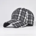 Detail view of the classic black and white plaid baseball cap, winter hat, hard top design. - Adjustable / 25