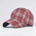 Red plaid winter baseball cap detail showing fabric texture, classic patterned curved brim hat. - Adjustable / 18